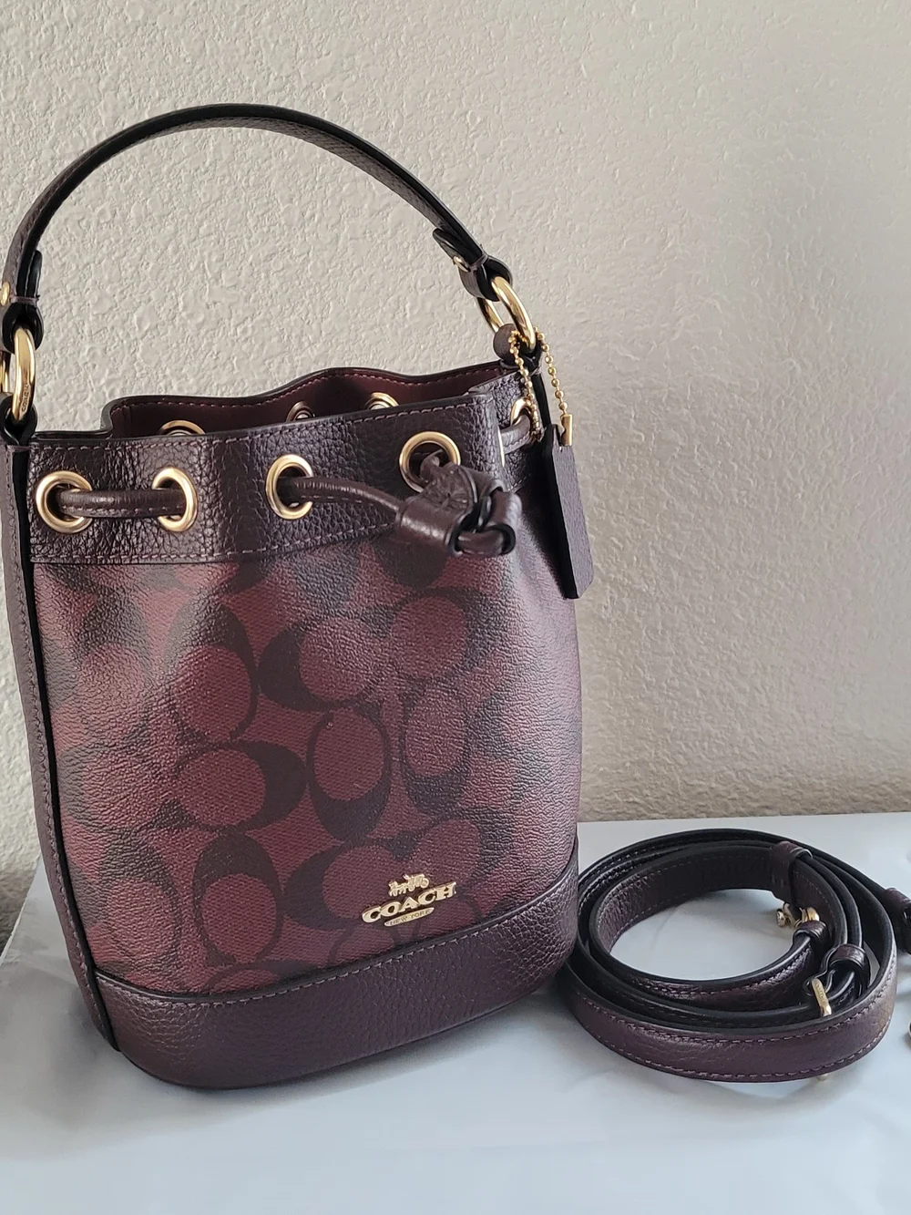 NWOT Coach burgundy Dempsey bucket bag with adjustable drawstring,